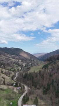 Bicaz valley aerial view with winding road in Romania spring