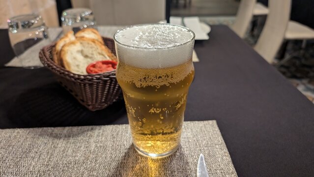 Glass of cold Cisk lager beer, Maltese iconic beer in Malta