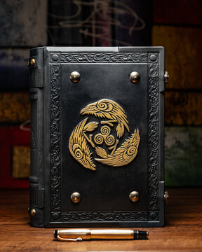 old black book with symbol with crows