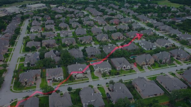 An aerial drone shot of a residential suburb with a rising red arrow graph tracking home costs