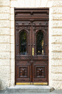 Neo-Baroque carved wooden entrance door in historic building, Odesa, Ukraine