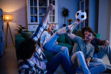 Friends cheering and celebrating while watching soccer game © Zoran Jesic