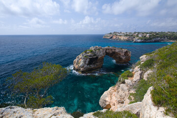 Fototapeta premium A gate-shaped rock off the coast of the island of Mallorca in the Mediterranean Sea