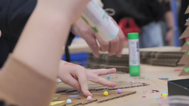 Child and Adult Creating Handmade Christmas Decorations with Cardboard and Colorful Craft Supplies