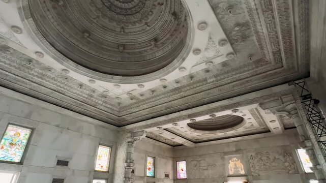 Birla Mandir Temple, Jaipur, India. A Majestic View of Elaborate Architectural Ceilings Featuring Intricate Designs and Stained Glass Windows Illuminating the Interior Space