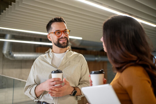 Colleagues having coffee break and casual conversation in office