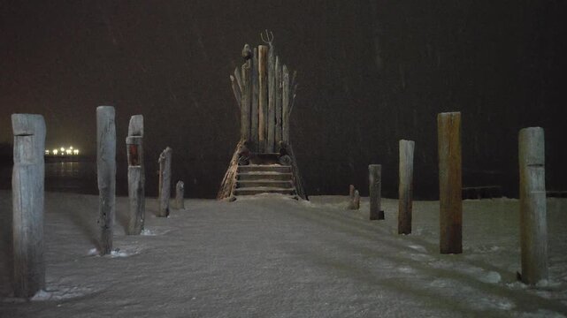Snow Covered Wooden Throne Structure at Night