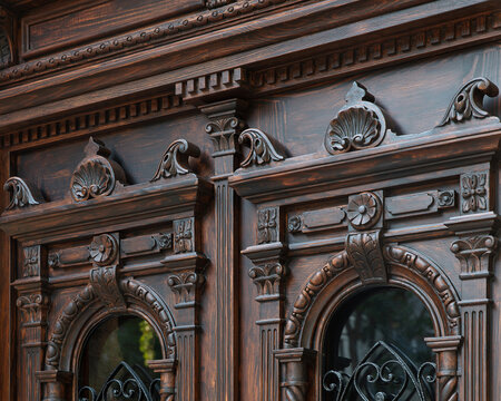 Neo-Baroque carved wooden door detail with ornate floral decorations and wrought iron windows, Odesa Ukraine
