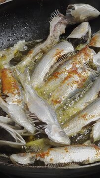Frying Sardine Fish In Spicy Oil in Pan

