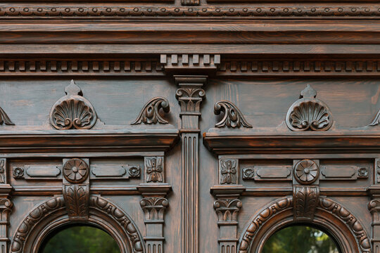Neo-Baroque carved wooden door detail with ornate floral decorations and wrought iron windows, Odesa Ukraine