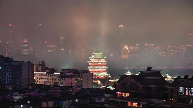 Tengwang Pavilion illuminated at night in misty Nanchang skyline in Tengwang Pavilion, Nanchang, Jiangxi, China