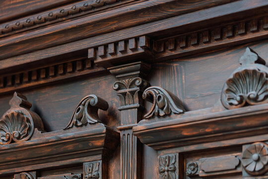 Neo-Baroque carved wooden door detail with ornate floral decorations and wrought iron windows, Odesa Ukraine