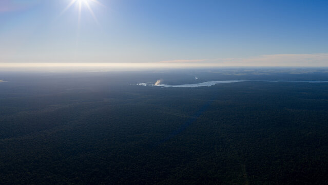 Panoramic Aerial View of Iguazu River and Distant Iguazu Falls Under Strong Sunlight in Argentina