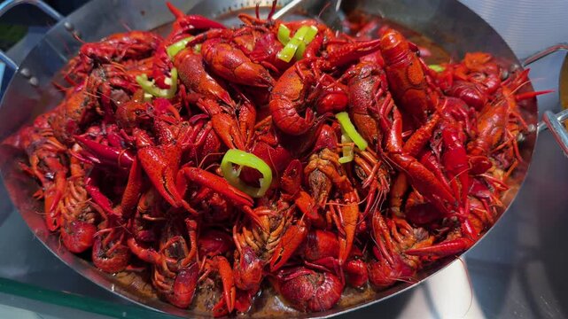 Boiled crayfish with onion in a pan. Slow motion