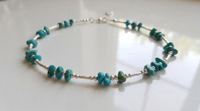 Delicate turquoise ankle bracelet on white surface