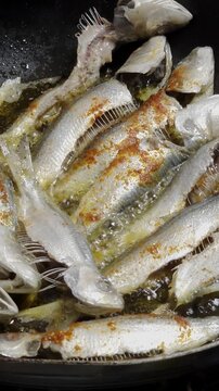 Frying Sardine Fish In Spicy Oil in Pan

