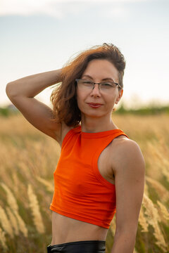 Woman in Orange Crop Top in Golden Field