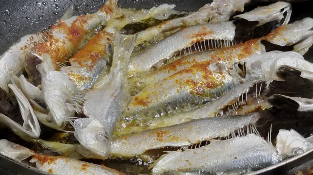 Frying Sardine Fish In Spicy Oil in Pan

