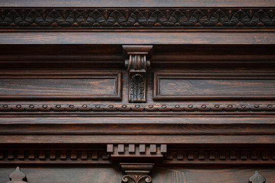 Carved wooden door cornice detail with modillions and ornamental molding, restored historic entrance Odesa Ukraine
