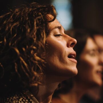 a woman sings in a church choir