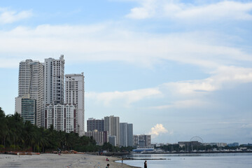 Fototapeta premium Manila skyline. Lines of buildings by the coastline in a busy city. Manila Bay skyline.