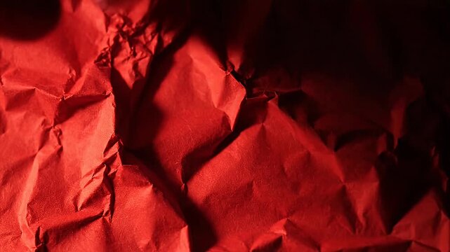 Abstract red crumpled paper texture for backgrounds and design