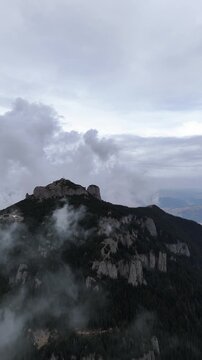 Toaca Peak rocky summit surrounded by mist Ceahlau Romania