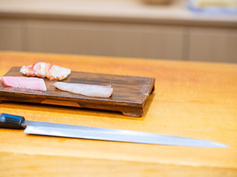 Sliced Sashimi Pieces on Wooden Cutting Board Sushi Counter Prep Sashimi Pieces Cutting Board Side A