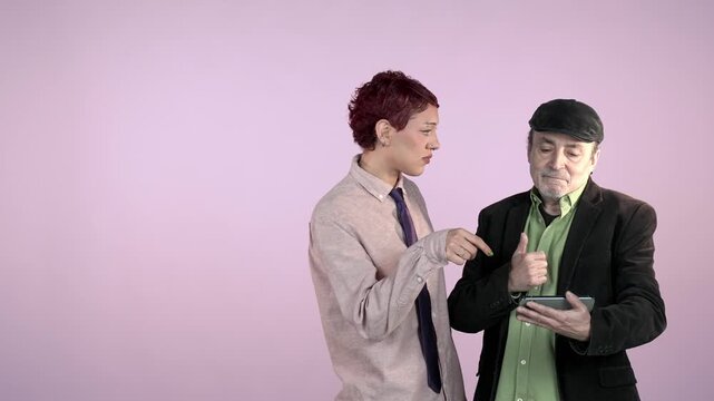 Young employee explaining a mobile app to an older man on a tablet