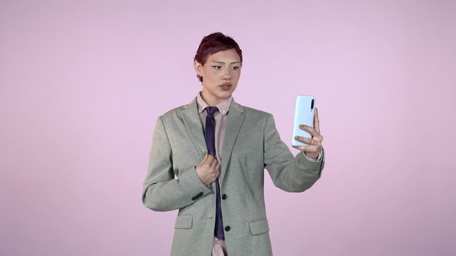 Androgynous business person taking selfies with smartphone