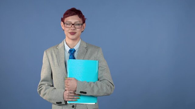 Young businessperson holding folder and smiling at camera