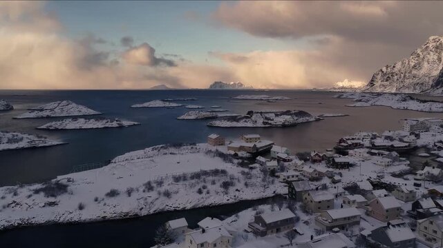 Aerial view of a snow-covered Norwegian village nestled among fjords and mountains