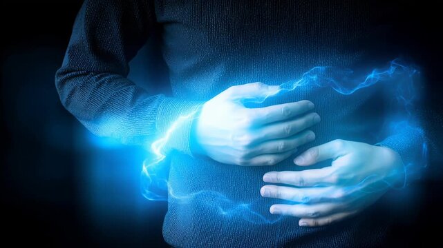 Signs of stomach disease in a person holding their abdomen in a dark room