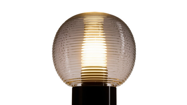 Isolated modern spherical table lamp with ribbed amber glass shade glowing brightly
