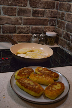 Frying potato zrazy with cabbage filling in a pan on an induction stove. Crispy golden fried patties served on a plate, showcasing the final step of cooking traditional Eastern European rustic comfort