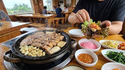 Obraz premium .Traditional Korean Barbecue (Samgyeopsal) Dinner Table with Side Dishes