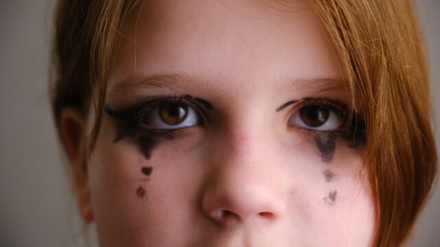 Close‑up shot captures a girl&rsquo;s mesmerizing eye, framed by dramatic stage makeup. Face paint. Performance on stage. Close‑up captures a girl&rsquo;s eye in the quiet moments before the curtain rises.