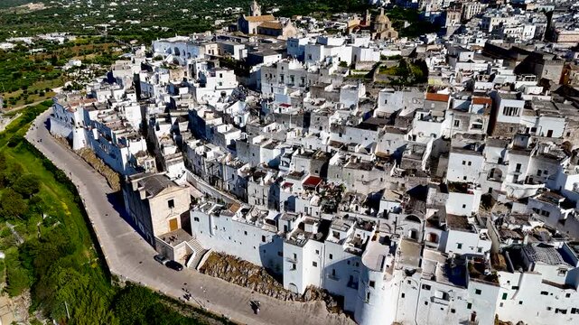 Ostuni, the White City of Puglia. Aerial 4K drone video footage with view of panorama of historic Italian architecture and Mediterranean landscape. Whitewashed old town