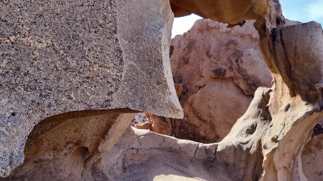 Amazing natural arch carved by erosion in the arid landscape of Fuerteventura. Stunning geological formation in the Barranco de Las Penitas
