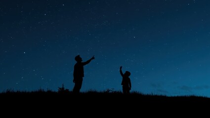 Fototapeta premium Father pointing at stars with son on Fathers Day.
