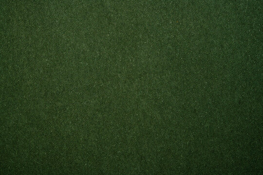 Dark green felt fabric creating a textured background without distractions