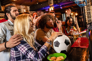 Obraz premium Mixed emotions football fans cheering and feeling sad during a soccer match in a pub.