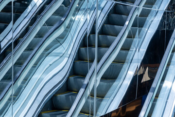 Fototapeta premium Abstract escalator reflection on mirrores building facade