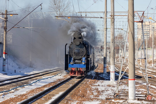 A retro tourist steam locomotive travels along the railway