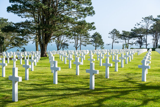 Military memorial cemetery in Normandy, France, with white crosses honoring American soldiers killed in battle during WWII