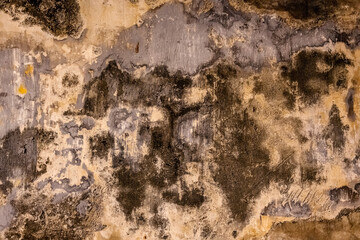 Fototapeta premium Abstract weathered wall with dark organic textures and painterly mineral patterns. Detail of an old surface at Fortaleza do Monte in Macau.