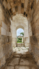 Fototapeta premium A view through the famous Victory Arch of ancient Anavarza in Kozan, Adana, a monumental three-arched Roman gate built in the 3rd century and marking the beginning of the ancient world’s remarkable co