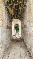 Fototapeta premium A view through the famous Victory Arch of ancient Anavarza in Kozan, Adana, a monumental three-arched Roman gate built in the 3rd century and marking the beginning of the ancient world’s remarkable co