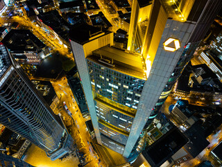 Naklejka premium High-angle view of the Commerzbank Tower illuminated at night in an urban setting