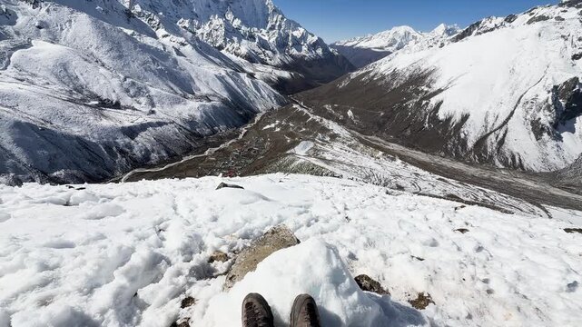 Hiker boots in snow overlooking Dingboche village in Himalayas, Nepal